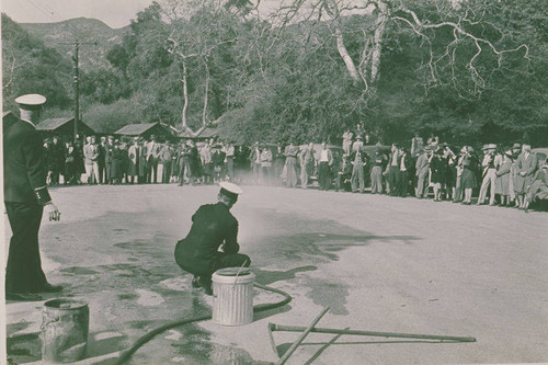 Firemen demonstrating how to extinguish phosphorus bombs in the event of an attack at Assembly Camp, Temescal Canyon, Calif