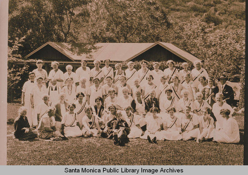 Religious group poses together behind "The Tabernacle" in front of one of the school rooms on the Assembly Ground in Temescal Canyon, Pacific Palisades, Calif