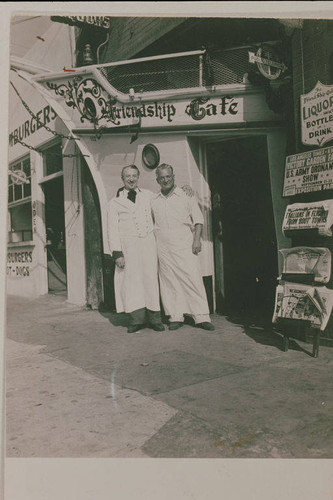 Two men (Dr. Laws on the left) stand in Front of the Friendship Caf in Santa Monica Canyon