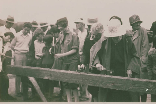 People hammering nails into a piece of wood, Pacific Palisades, Calif