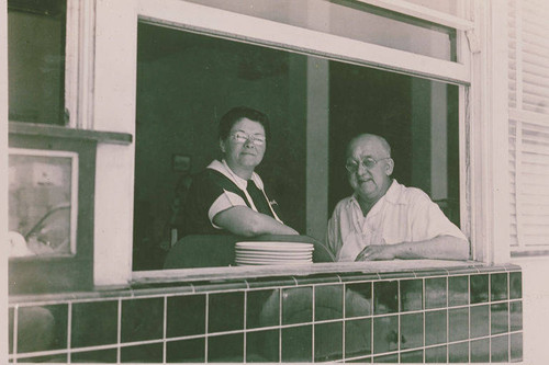 A man and a woman looking out of a restaurant window, Pacific Palisades, Calif