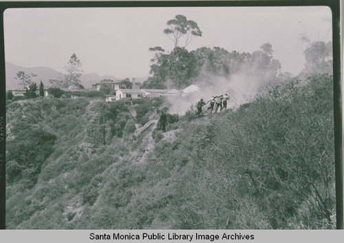 Firefighters battlilng a brush fire in Las Pulgas Canyon, Calif