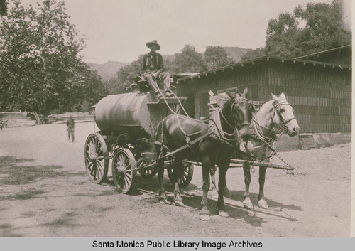 Man driving a mule and horse drawn water truck in Temescal Canyon