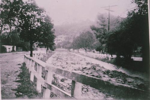 Flood water rushing down a creek in Santa Monica Canyon, Calif