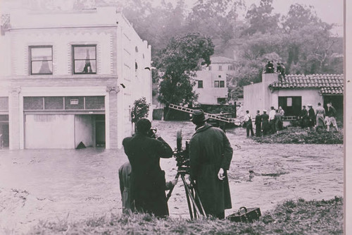 Newsreel crew filming a rescue attempt in flood damaged Santa Monica Canyon, Calif