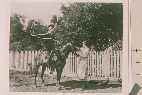 Motion picture still from Will Rogers film showing Rogers roping