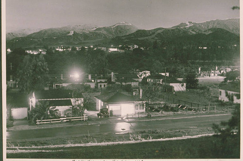 View across Via de La Paz at night with snow in the mountains, Pacific Palisades, Calif