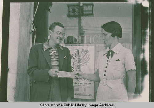 A man and woman promote savings bond sales in front of the Post Office in Pacific Palisades