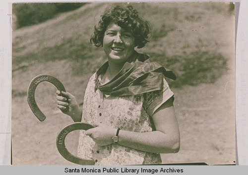 Margaret Jane Work holding horse shoes at the Institute Camp in Tesmescal Canyon, Calif