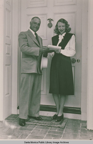 Unidentified couple standing at their front door in Pacific Palisades