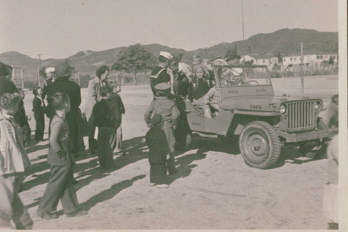 Children lined up by a Coast Guard vehicle in Pacific Palisades, Calif