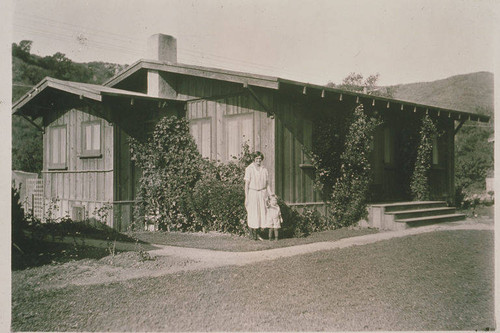 Zola Clearwater and her son, Clifford Clearwater, Jr. in front of their home, one of the first houses built in Temescal Canyon, Calif