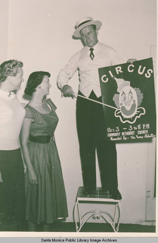 Man showing a sign advertising a circus, Pacific Palisades, Calif