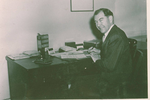 Portrait of an unidentified man at his desk