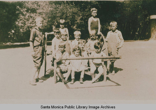 Two big brothers taking the kindergarten children for a ride in a cart, Temescal Canyon, Calif