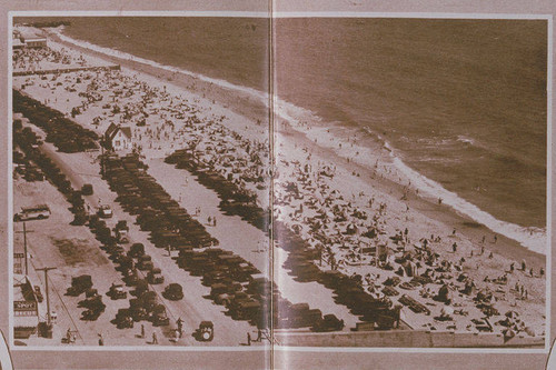 Automobiles and crowds in a Santa Monica beach scene appearing in an article for "Pictorial California Magazine," July, 1930