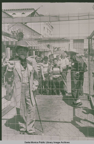 Arthur Loomis, President of Santa Monica Land and Water Company, in costumes at Fiesta day in Pacific Palisades with a group of children in the background