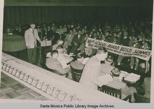 Crowd with banner assembled to demonstrate for the building of the Paul Jr. High Revere School, Los Angeles, Calif