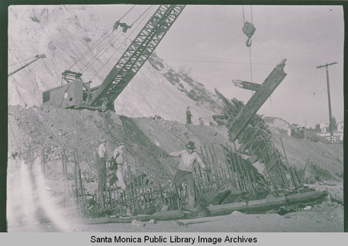 Workers pull up the last bits of wreckage from the barge ''Minnie Cain'' near the Bel Air Bay Club