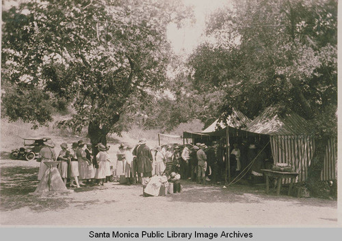 People lining up at tents at the Chautauqua Camp in Temescal Canyon