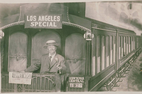 Man on a mock-up of a railroad car at a fun park in Pacific Palisades, Calif