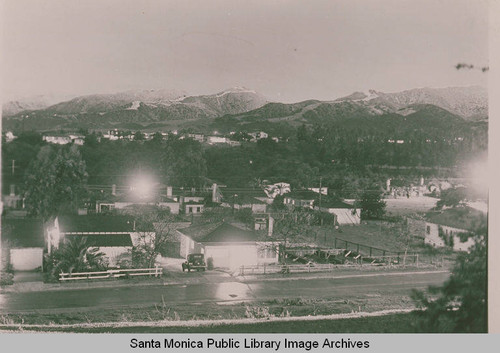 View across Via de la Paz at night with snow in the mountains, Pacific Palisades, Calif