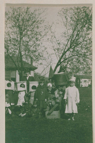 Marquez family and other children in costumes standing in front of Canyon School in Santa Monica Canyon