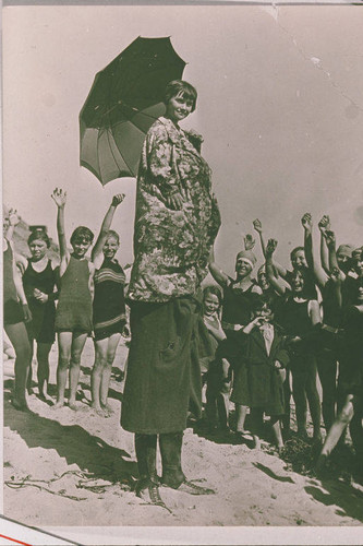 Child sitting on someone's shoulder at Santa Monica beach