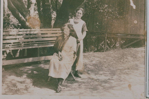 Unidentified woman having her hair brushed by Mrs. Jessie Smith in Temescal Canyon , Calif