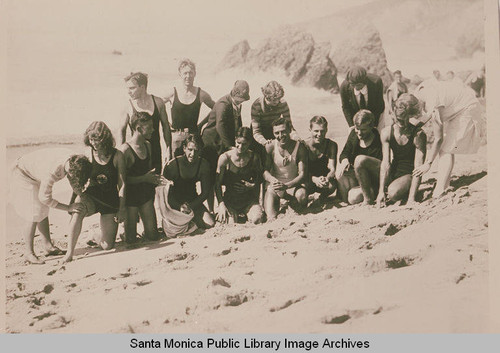 Swimmers being "greased" on the beach near Pacific Palisades, Calif