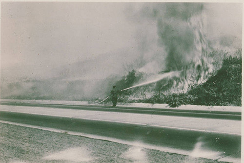 A firefighter battling flames in Pacific Palisades, Calif