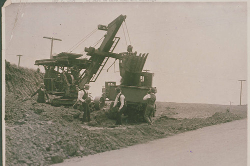 Inspectors by a steam shovel at a construction site in Hungtington Palisades, Calif