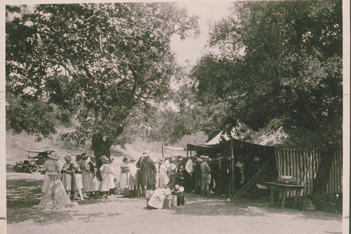 People line up among the tents at Institute Camp in Temescal Canyon, Calif