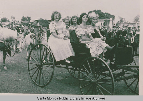 Women in costume riding in a carriage in the Pacific Palisades Fiesta Day Parade