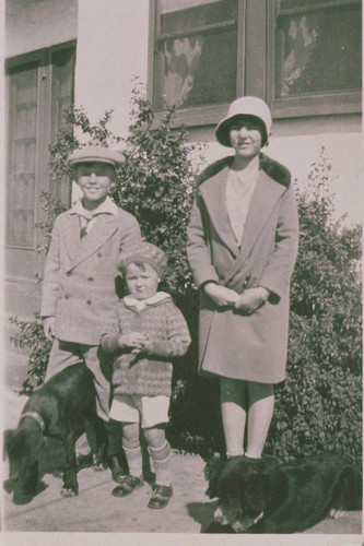 Children in hats and coats in front of the house at 920 Iliff Street in Pacific Palisades, Calif