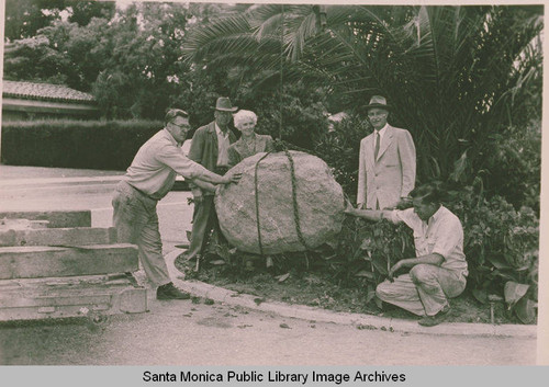 Setting the stone for the Ysidro Reyes Family landmark near the site of the old Reyes adobe, with Mrs. Kennedy representing the Landmark Society