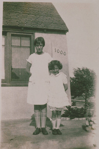 Frances Smith with a younger child in front of the C. H. Smith house at 1000 Galloway Street in Pacific Palisades