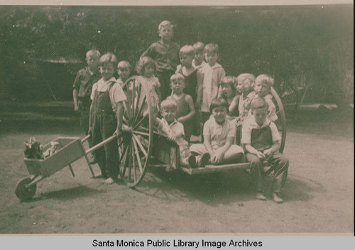 A portrait of children with a wheelbarrow and cart, Temescal Canyon, Calif