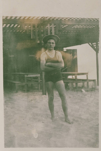 Lifeguard Noel Rust in bathing suit on the beach near the bath house in Santa Monica, Calif