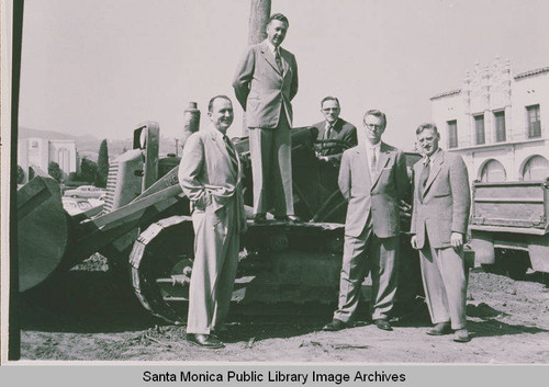 Men standing next to a bulldozer used to remove trees for the building of Pacific Palisades Medical Dental Center in Pacific Palisades, Calif