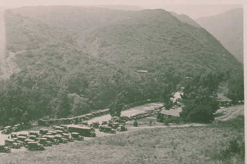 Automobiles parked in front of Assembly Camp buildings in Temescal Canyon, Calif