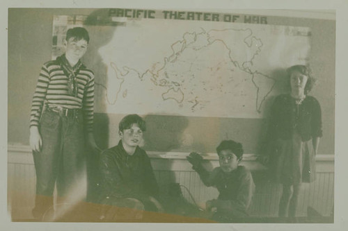 Children from Canyon School (in Santa Monica Canyon) with map of the "Pacific Theater of War" displayed in a classroom during World War II