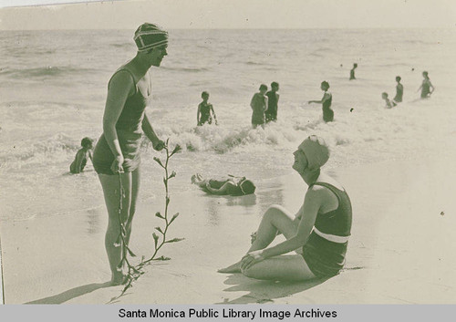 Two women and a seaweed jump rope near the surf, Pacific Palisades, Calif