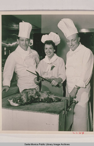 Mrs. Jerry Lewis (center with carving knives), Sid Koskoff and Fred Smith (cook) at Ted's Grill in Santa Monica Canyon