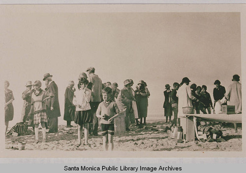 Children and adults having breakfast at the beach with Dr. Edwards' nature study class