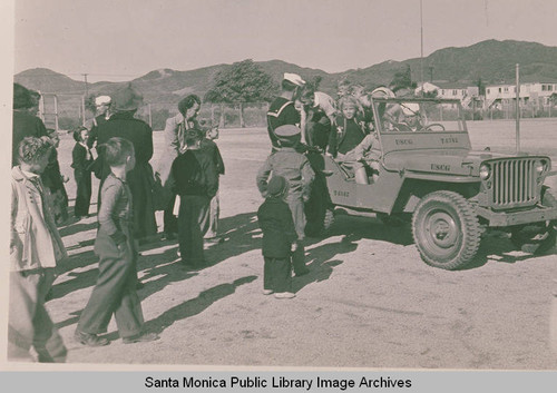 Children admire jeep and soldiers in Pacific Palisades during World War II