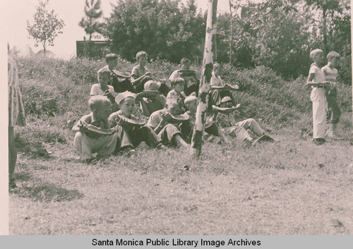 Children eating watermelon on grounds of Pacific Palisades Elementary School