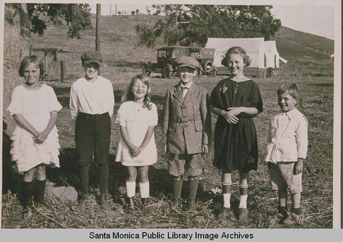 The first children of the Pacific Palisades standing in front of tents and early model cars