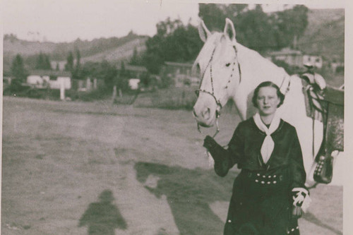 Frances Stewart with a horse at the "Hot and Tot Riding Academy," in Pacific Palisades