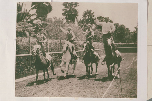 Will Rogers Family (left to right Will Sr., Mary, Jim, and Will Jr.) riding and roping at the Tan Bark Arena in Beverly Hills